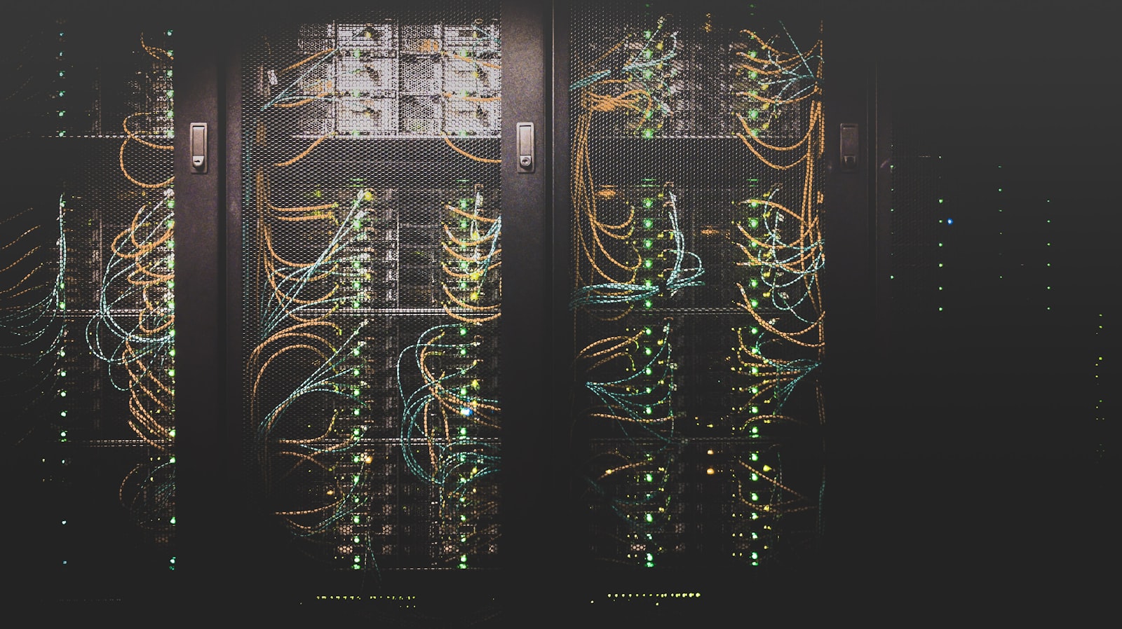 Server room with racks of equipment lit in cool blue light